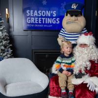 Santa and Louie pose with young boy
